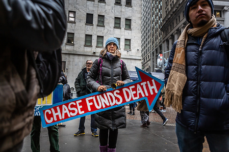 A protester seen carrying an anit-Chase sign during the march.
Activists blocked the entrance of a Chase Bank in downtown Manhattan for over 3 hours in an action that the organizers said is to hold banks accountable for their role in climate change. Chase is the top US funder of some of the most extreme fossil fuels and a leading financier of two of the largest private prison companies. Three protesters were arrested.