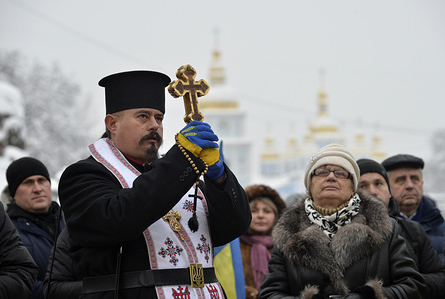 A priest seen with a cross taking part in a rally in front of St. Sophia cathedral during the Church's unification council for the establishment of the independent Ukrainian Orthodox Church.