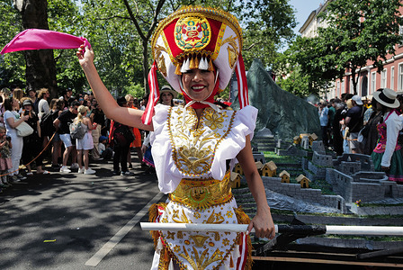 A female participant in a costume entertains the crowd during the event. After a three-year hiatus due to the Covid-19 pandemic, the Berlin Carnival of Cultures has finally resumed its tradition this year. Carnival of Cultures is a celebration of the capital's diversity and internationality. It is celebrated annually since 1995, which attracts numerous Berliners and tourists to join and spectate their colorful and diverse parades.