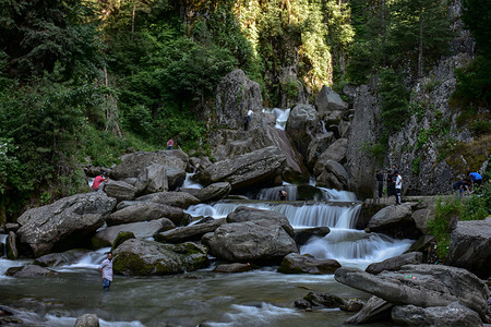 Visitors explore the Shrunz waterfall during a hot summer day in Chandoosa area of disrtict Baramulla, about 60kms from Srinagar, the summer capital of Jammu and Kashmir. After respite from hot weather, temperatures rose in Srinagar to settle at 34.2°C with Weatherman forecasting isolated showers across the region.