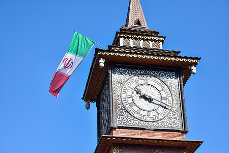 A national flag of Iran is seen installed on the clock tower following the killing of Iranian Supreme Leader Ayatollah Ali Khamenei in Srinagar.