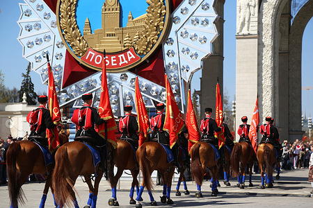 The Kremlin Equestrian School's horsemen with Soviet Union flags seen during performance dedicated to Victory Day 9 May at the VDNKh. The Kremlin Equestrian School was founded in 2006 under the aegis of the Moscow Kremlin Commandant’s Service of the Federal Guard Service of the Russian Federation.