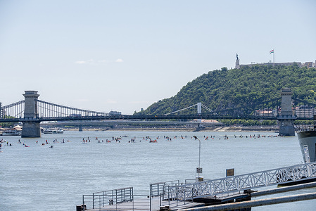 The Stand-up paddleboarding (SUP) paddlers reached the Chain Bridge in Budapest. Stand-up paddleboarding (SUP) festival is an annual event in Budapest, Hungary. This year the festival celebrated the 10th anniversary. The organizers expected 300-400 people to attend on the 15 km long journey on the Danube River.