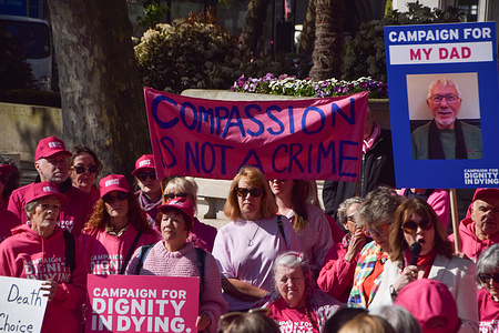 Protesters hold placards and banners in support of the Assisted Dying Bill during the demonstration. Supporters from the group Dignity In Dying gathered in Parliament Square urging the House of Lords to pass the bill which would allow terminally ill people to end their lives.