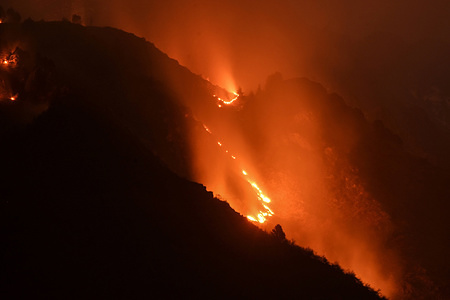Flames and smoke rise from the Zabarwan mountains in Srinagar, Indian administered Kashmir. A major fire engulfed in the Zabarwan range at Brein Nishat area on late Sunday evening. Reports said the fire started at upper reaches on Brein and spread to adjoining forests.