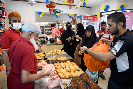 Muslim devotees buy traditional food from a confectionery in Dhaka for the preparation of the holy Shab e-Barat. The Muslims consider Shab-e-Barat one of the three most sacred nights as they believe that it is the time when Almighty Allah decides the fate of all human beings for their rizq or livelihood for the following year. The observance involves a festive night-long vigil with prayers and in some regions, it is also the night to commemorate their deceased ancestors.