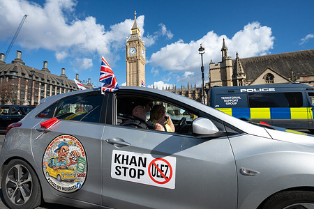 Motorists drive cars and an antique fire engine around Parliament Square during a “Protest Convoy To End The London Drivers Rip-Offs,” and against the expansion of the Ultra Low Emission Zone (ULEZ) in the capital. The convoy circled the area near the Palace of Westminster criticizing transport policies introduced by the Greater London Authority, arguing that the measures unfairly penalize motorists.