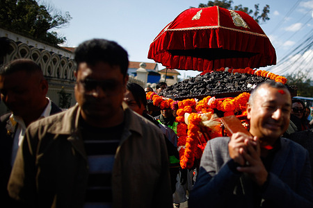 Residents and cultural groups carry the historic Toran, a carved wooden structure stolen from the house of the Living Goddess Kumari. It was recently returned from the Barakat Gallery in London back to its original shrine with traditional music and celebrations after being taken two decades ago.