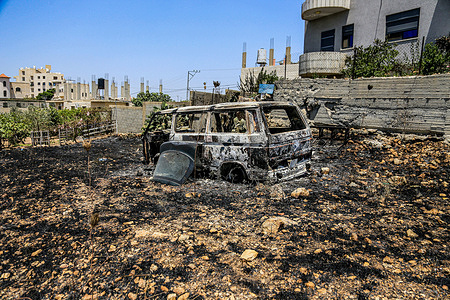 Charred remains of a vehicle are seen after it was set on fire by Jewish settlers in the village of Tell, southwest of Nablus in the West Bank. Israeli settlers set fire to Palestinian homes and vehicles in Tell and the nearby village of Sarra following the killing of two Israeli settlers and four Palestinians in Tell, southwest of Nablus, in the occupied West Bank. The Israeli military also announced preparations for an operation in the northern West Bank.
