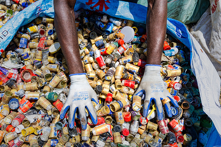 A waste picker sorts discarded glass bottles and aluminum labels for recycling at the Likoni Dumpsite along Likoni Road in Industrial Area, Nairobi, Kenya, before selling the recovered materials to recycling dealers for income. As Nairobi grapples with growing waste, hundreds of waste pickers at the Likoni dumpsite along Likoni Road in Industrial Area recover discarded materials, helping divert waste from disposal, reduce pollution risks and limit waste entering waterways while supporting the city’s resource recovery and environmental conservation efforts.