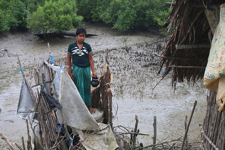 A boy stands inside a makeshift unhygienic hanging latrine at a village in Satkhira.
The coastal area of Bangladesh is experiencing a Sanitation crisis which is getting worse day by day. Children are the main victims and nearly half the population in coastal areas have no access to improved sanitation facilities, impacting their health, safety, dignity and economic opportunities.