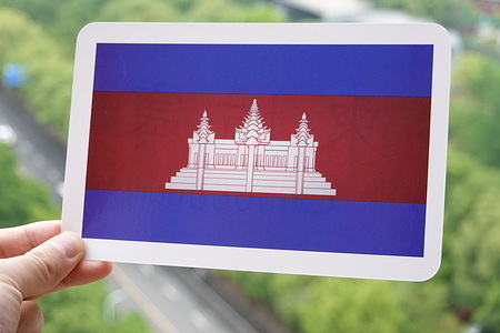 In this photo illustration, the Cambodian flag is printed on a white card.