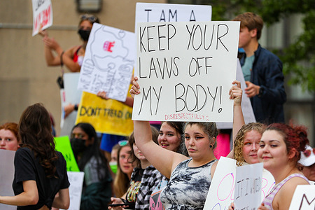 Abortion-rights protesters hold placards during a rally at the Columbia County courthouse. About 100 people attended the rally, which was organized in response to a leaked draft of a Supreme Court decision that would end federal protection of abortion rights in the United States.