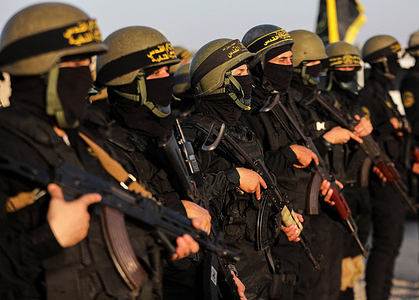 Members of the Al-Quds Brigades, the military wing of the Islamic Jihad Movement, participate in a military parade on the occasion of the 36th anniversary of the founding of the movement in the southern Gaza Strip.