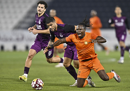 Paulo Silva (C) of Al Sadd SC and Jean Evrard Kouassi (R) of Umm Salal SC seen in action during the Qatar Stars League match between Al Sadd SC and Umm Salal SC at Al Thumama Stadium. Final score Al Sadd SC 2 : 5 Umm Salal SC.