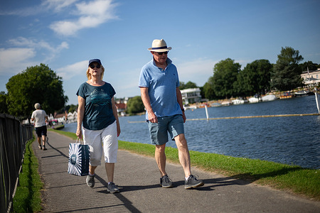 Tourists and locals walk along the Thames enjoying the sun while the country set to experience a heatwave this week, with temperatures expected to reach as high as 32 degrees Celsius today. The UK Health Security Agency (UKHSA) has issued a yellow heat health warning across all areas of country, except the North East and North West.