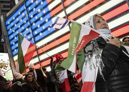 Demonstrators march to Times Square holding flags during an organized rally 'March for Iran's Freedom' by Lion and Sun. Hundreds of marchers passed the Consulate General of Israel and ended in Times Square. It is day 15 since the United States and Israel started a war attacking Iran and killing the Supreme leader Khamenei in an airstrike.