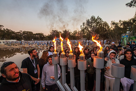 Hanukka menorah' torches are lit at the Nova festival memorial site. The holiday was held at the memorial site of the NOVA festival, near the southern border in Israel where almost 400 young men and women were murdered and hundred injured and kidnapped to the Gaza strip during the Hamas brutal terrorist attack on Oct 7th. 2023. Many relatives gather during the eight days of Hanukkah holiday and light the Menorah, a Jewish tradition that has lasted for 2000 years,
