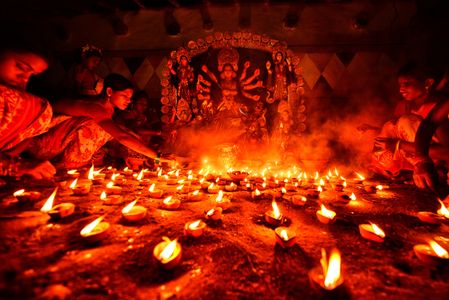 Hindu devotees light Diyas (clay made lamps) in front of the idol of Lord Durga during the Ritual of Durga puja at a remote village of Purulia. Durga is a description of the power of the goddess in Hindu Mythology. UNESCO (The United Nations Educational, Scientific and Cultural Organization) in 2021 included Durga puja in the Representative list of the intangible cultural heritage of Humanity.