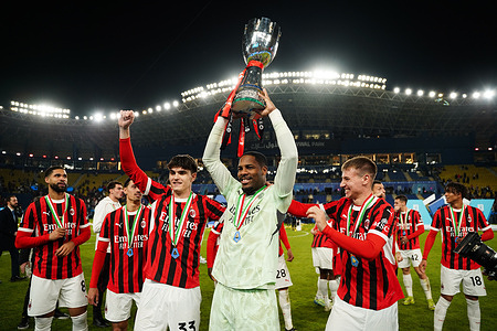 AC Milan's players celebrate with the trophy after winning the Italian Super Cup final football match between Inter Milan and AC Milan at Al-Awwal Park. Final results Inter Milan 2 : 3 AC Milan.