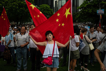 A woman embraces a Chinese flag during pro-government Safeguard Hong Kong rally at Tamar Park.
Government supporters show up in number of tens of thousands in a pro-police rally, at Tamar Park. Named Safeguard Hong Kong, the demonstration was co-organized by 70 pro-Beijing figures and was attended by local residents, mainland immigrants, members of ethnic minorities, as well as visitors from across the border.