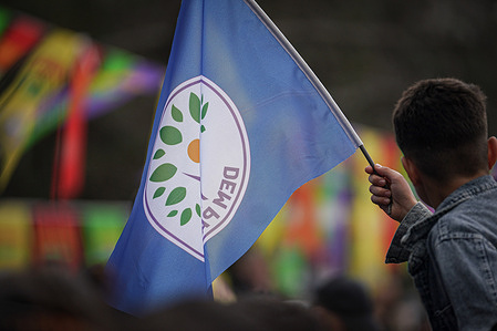 A DEM Party flag seen at the Nowruz event. Hundreds of people gathered to celebrate Nowruz welcoming the arrival of spring. On this special day it symbolises the reawakening of nature and new beginnings, The event was a colourful spectacle with messages of unity and solidarity taking centre stage.