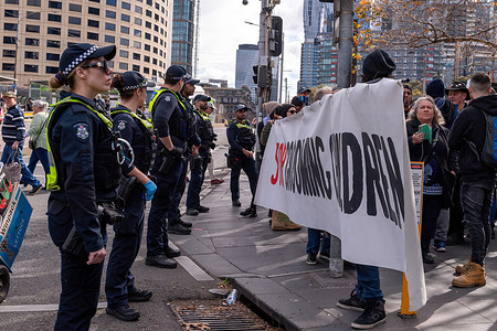 Police keep anti-trans protesters from crossing the street during counter demonstrations at the Melbourne Convention Center. Protesters and counter protesters clash with divergent ideologies about Melbourne's Drag Expo. As the colorful event became a backdrop for societal tension, passionate protesters and counter protesters engage in protests and clashes. Amidst this charged atmosphere, a substantial police presence worked to maintain order, trying to keep the two groups separate and maintain public safety.