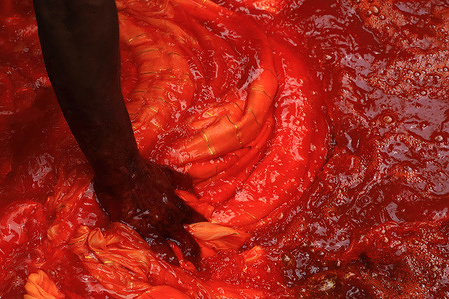 A worker seen applying colour to the fabrics at the dye factory in Narayanganj.