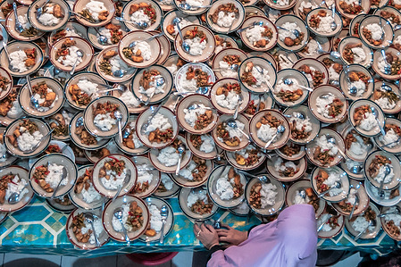 Plates of food of Indonesian Muslims gathered for iftar (fast-breaking) dinner seen during the holy month of Ramadhan at Jogokariyan Mosque in Yogyakarta, Indonesia. Muslims around the world celebrate the holy month of Ramadhan by praying during the night time and abstaining from eating and drinking during the period between sunrise and sunset.