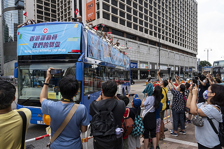 Crowds receive the participants of Hong Kong Olympic athletes delegation during a bus parade to celebrate the six medals won at the Tokyo Olympics 2020.