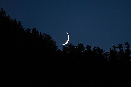 General view of crescent moon rising over the mountain in Kokernag area of Anantnag district, south of Srinagar Kashmir.