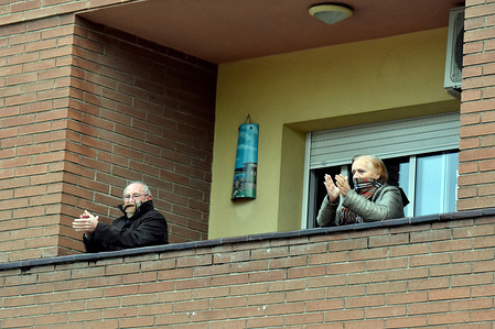 A couple applaud from the terrace of their house to show gratitude to the Covid-19 fighters.
In Spain, every night at 08:00 pm and all the cities of the country, citizens who are confined at home during the state of alarm decreed by the Government of Spain since March 16, go out to their terraces and applaud to show gratitude to all the people such as health workers, police, fire fighters, supermarket staff, truckers, and cleaning staff for their great work in fighting the Covid-19 crisis.