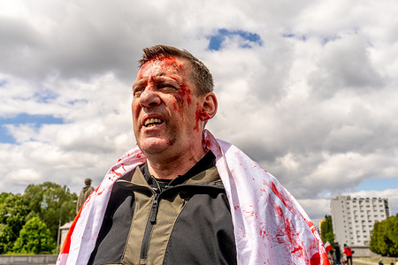 Ukrainian protesters with blood-resembling makeup shout slogans as they take part in a counter demonstration during the 80th anniversary of Victory Day and the end of WWII in Europe. On May 9 in Warsaw, dozens of Ukrainian activists gathered at the Soviet Military Cemetery to protest against the presence of Russian officials marking Victory Day. Russia’s Ambassador to Poland, Sergei Andreyev, along with his delegation, laid a wreath at the monument commemorating Soviet soldiers who died during World War II. The event was disrupted by demonstrators expressing opposition to Russia’s ongoing aggression in Ukraine. Victory Day, celebrated on May 9 in Russia, honors the Soviet Union’s triumph over Nazi Germany in 1945.