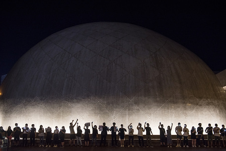 Protesters illuminated cellphones and hold hands to form a human chain at the Hong Kong Space Museum during the Hong Kong Way anti-government rally across Kowloon in Hong Kong. Mass demonstrations continue one more weekend in Hong Kong which began in June 2019 over a now-suspended extradition bill to China.