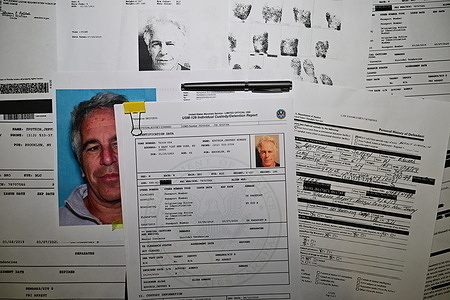 In this photo illustration, the Released documents from the U.S. Justice Department files on Jeffrey Epstein. Handouts of released documents related to court cases against late financier and convicted sex offender Jeffrey Epstein, issued by the U.S. Justice Department, are seen printed and arranged.