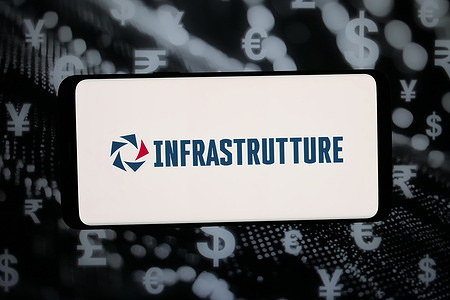 In this photo illustration, the logo of Italian energy company Infrastrutture S.p.A. is displayed on a smartphone in front of abstract background on computer screen.