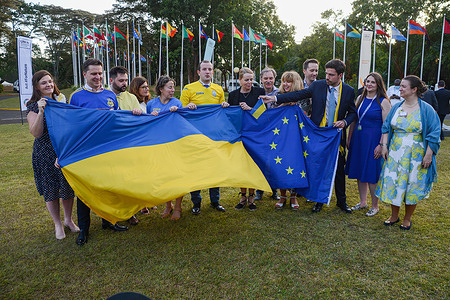 Delegates led by EU Commissioner for Environment, oceans and fisheries Virginijus Sinkevicius (6th L) are pictured holding Ukrainian and E.U flags in solidarity with Ukraine during the closing session of the Fifth session of the UN Environment Assembly (UNEA-5) at the United Nations headquarters in Gigiri.