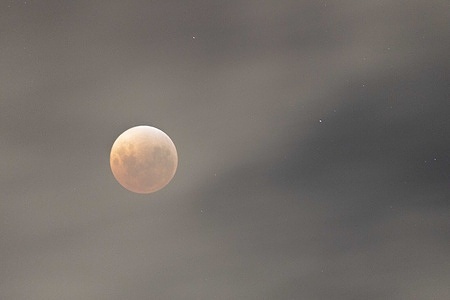 Clouds partially cover the moon at the peak of the lunar eclipse. A lunar eclipse is seen across Australia, including Melbourne, as the Moon passes into Earth’s shadow, creating a dramatic celestial display for skywatchers.