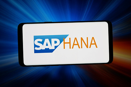 In this photo illustration, the logo of database management system SAP HANA is seen displayed on a smartphone in front of an abstract background on computer screen.