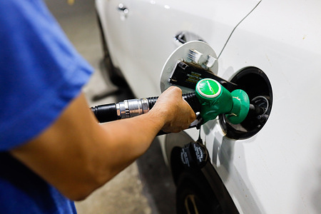 A gas attendant fills their car with petrol at a petrol station in Melbourne. Fuel prices in Australia are rising as global oil markets react to escalating tensions involving Iran, the United States and Israel in the Middle East. The conflict has disrupted key oil supply routes and pushed crude prices higher. Authorities are monitoring fuel retailers as price increases begin appearing at service stations across the country.