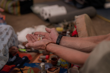 Dried psilocybin mushrooms prepared for administration. Indigenous shamans from South America travel to Ukraine's Transcarpathian region to conduct traditional ayahuasca and plant medicine ceremonies for participants seeking healing from war trauma and personal transformation. The retreats bring together traditional curanderos with Ukrainians including civilians and war veterans affected by war with Russia. Over two weeks, participants engage in various ceremonies involving sacred medicines like ayahuasca, DMT, San Pedro cactus, rapé tobacco, and sananga eye drops, all conducted inside a traditional tipi with a sacred fire that burns continuously. The ceremonies blend ancient Amazonian healing practices with the rural Carpathian landscape, creating a unique cross-cultural space for spiritual healing in a country ravaged by ongoing war.