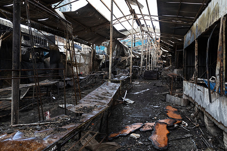 Charred metal frames and debris from the destroyed Lukianivskyi market are seen following a massive missile strike on the civilian infrastructure of Kyiv, Ukraine. The massive attack on Kyiv during the night of May 24, 2026, resulted in widespread destruction of civilian infrastructure in the Shevchenkivskyi district, with the area around Lukianivska Square serving as the epicenter. As a direct consequence of the strikes, the Kvadrat shopping center and the Lukianivskyi Market were completely gutted, leaving behind only charred structural remains and heaps of debris.
The powerful blast wave caused significant damage to the entrance hall of the Lukianivska metro station and shattered the facades, storefronts, and windows of neighboring commercial establishments, including pharmacies and retail shops. Within a one-kilometer radius of the square, residential buildings sustained heavy damage, with apartment blocks suffering collapsed ceilings, destroyed balconies, and widespread shattered windows.
This attack stands as one of the most devastating incidents to strike the district, leaving ruined administrative buildings and damaged homes as grim witnesses to the destructive force of the combined bombardment