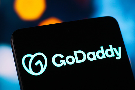 In this photo illustration, the GoDaddy logo is seen displayed on a smartphone screen.