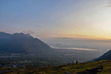 Visitors walk down a hill during sunset on the outskirts of Srinagar.