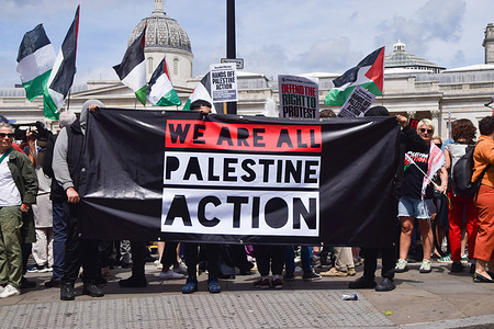 Protesters hold a banner in support of Palestine Action group during the demonstration. Supporters staged a protest in Trafalgar Square against government plans to ban the pro-Palestine activist group Palestine Action.