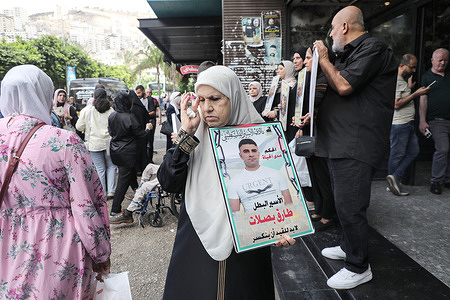 Families of Palestinian prisoners hold photos of their detained relatives during a solidarity rally in the city of Nablus, in the northern occupied West Bank. Palestinians staged a protest to demand a prisoner exchange agreement with the Israeli government and Hamas.
