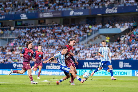 David Larrubia (C) of Malaga CF, Dani Barcia (R) and Mario Soriano (L) of Real Club Deportivo de la Coruña seen in action during the LaLiga Hypermotion 2025/2026 match between Malaga CF and Real Club Deportivo de La Coruña at La Rosaleda stadium. Final score Malaga CF 3 : 0 Deportivo de la Coruña