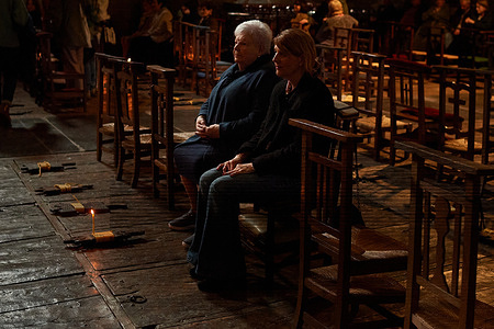 Parishioners at the wooden kneelers where the "argizaiolas" (candles) are lit during the All Saints' Day service at the Church of San Bartolomé in Amézketa, Basque Country.