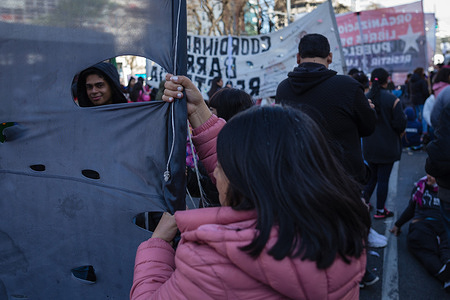 A protester holds a flag in the middle of the camp during the demonstration. The political organizations that make up the Picketers Unit held a camp for 48 hours, on July 9th Avenue, the most important avenue in the City of Buenos Aires, in front of the Ministry of Social Development to denounce the lack of response to their needs by the the government of President Alberto Fernández.