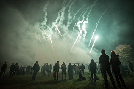 People seen looking at the fireworks while gathering to celebrate the Bonfire and firework display in Roundhay Park, Leeds.